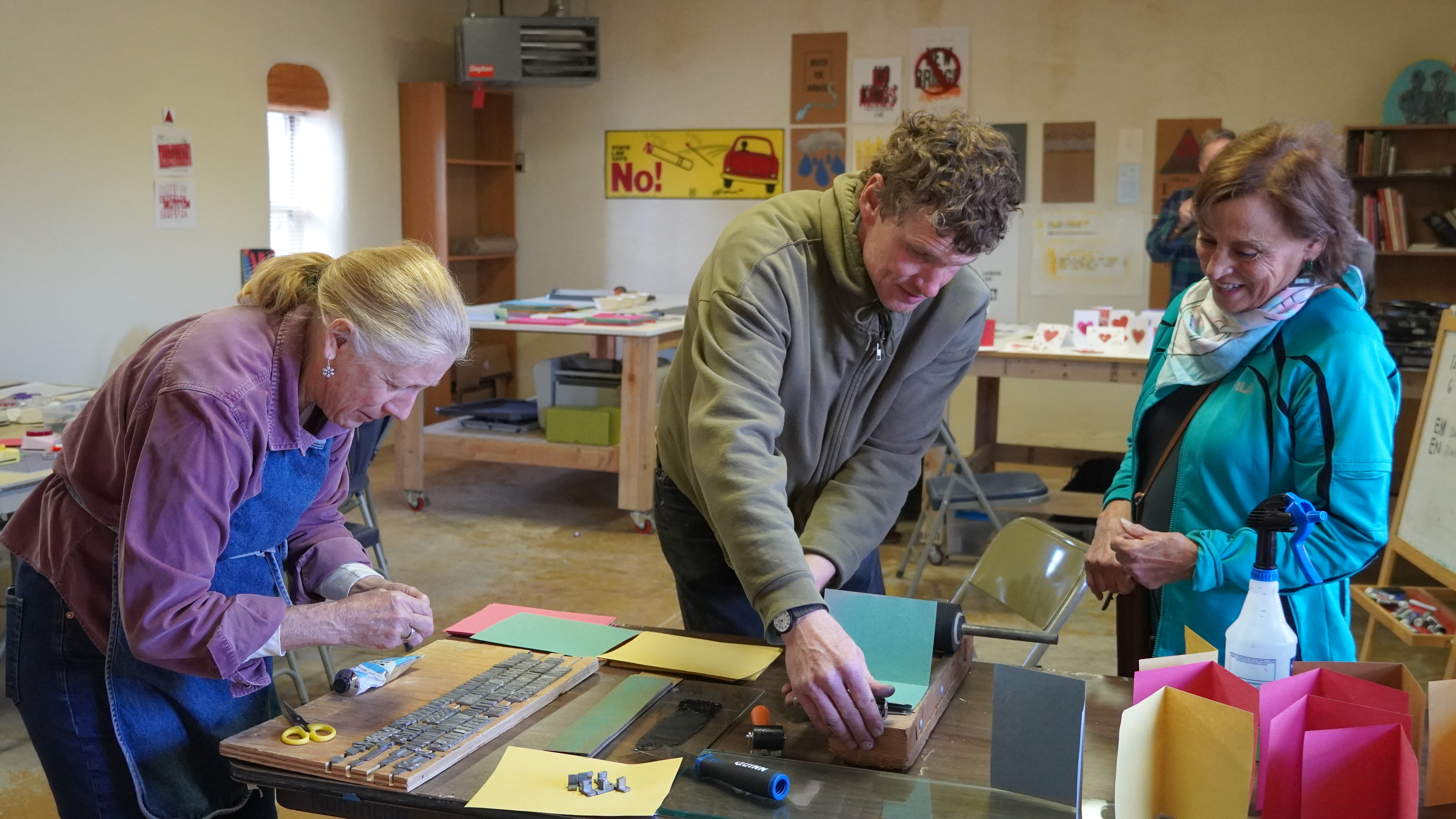 instructor Andrew Furse helping people with getting a print on thei valentine's card